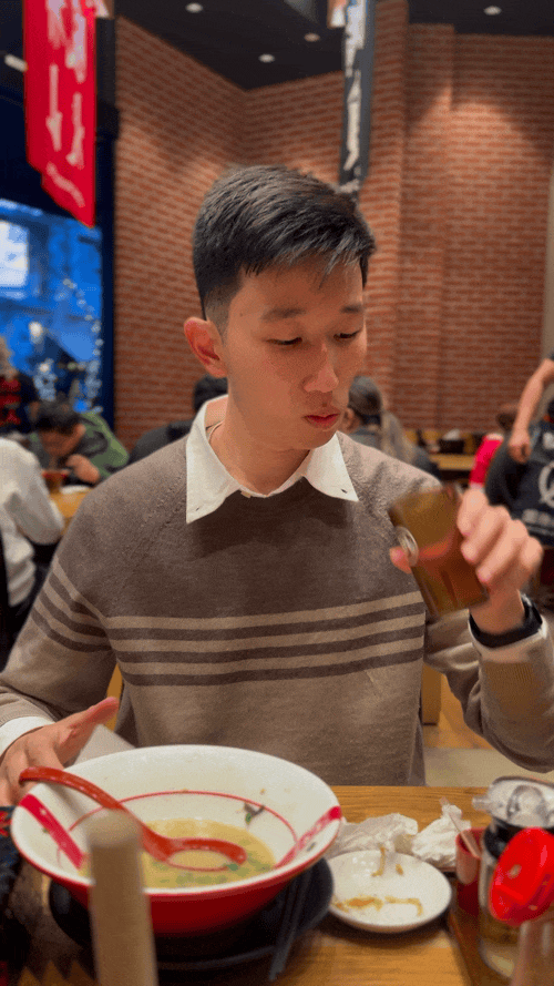 marcelo sips his drink at Haidilao